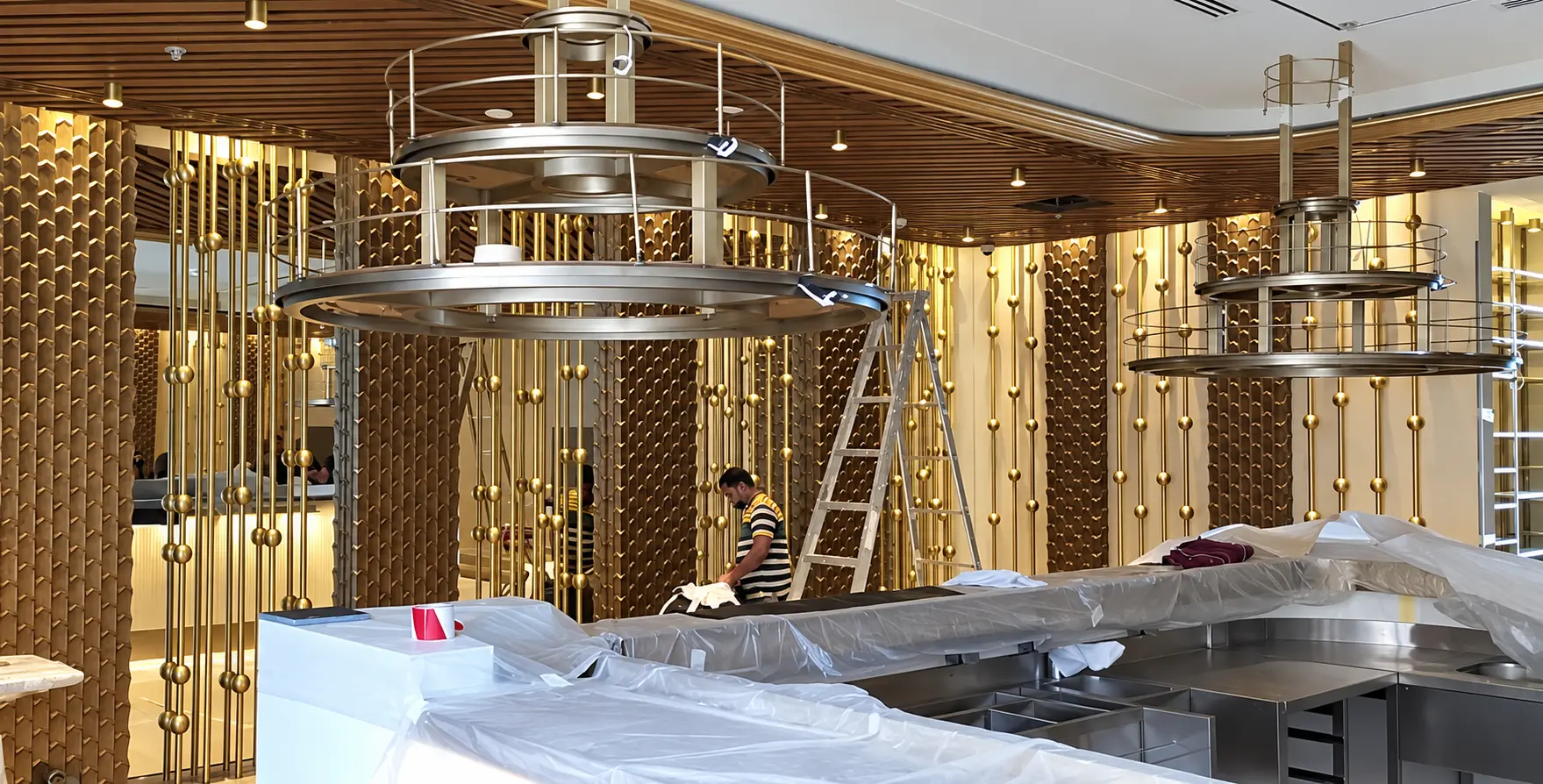 Installation in progress for gold and bronze decorative metal elements