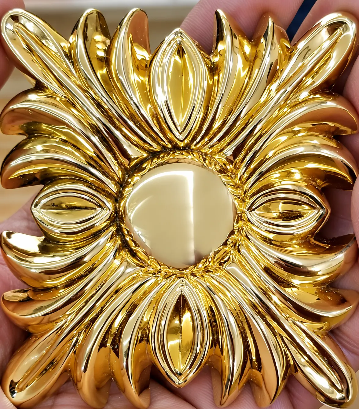 Close-up of a highly polished gold decorative metal component