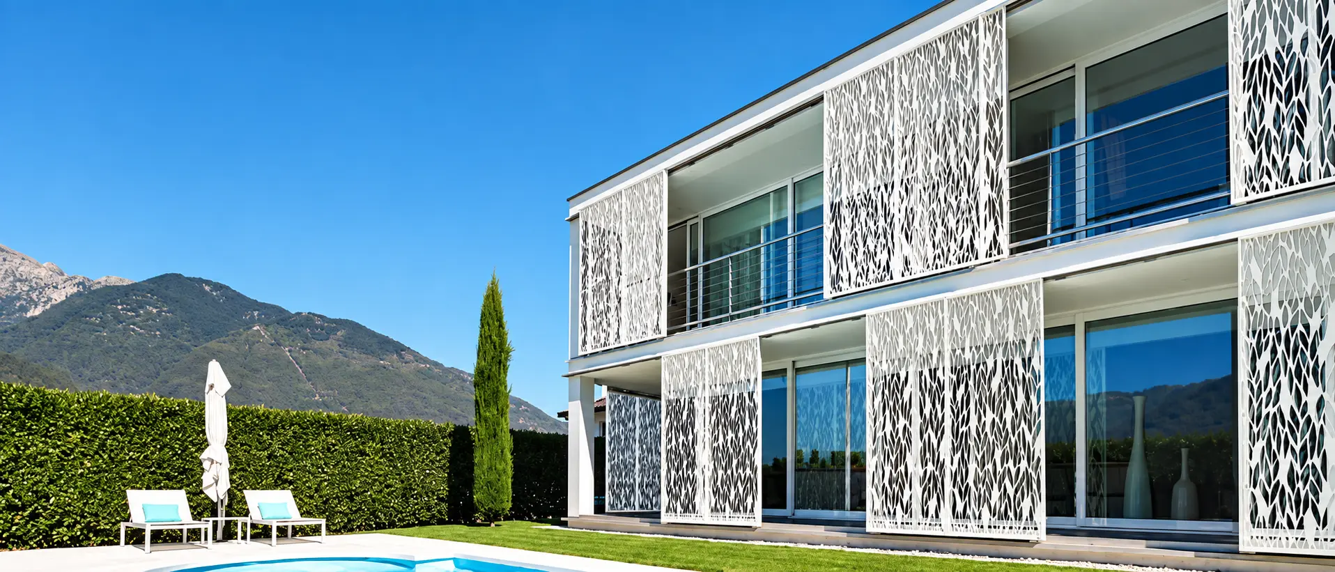 White patterned metal privacy screens across a modern villa façade
