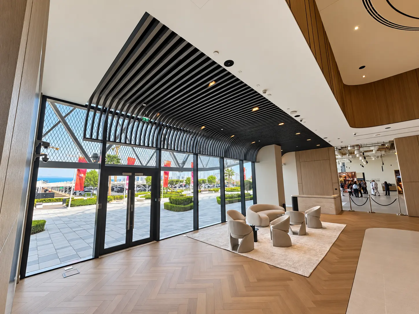 Black metal slatted canopy over a glazed architectural entrance